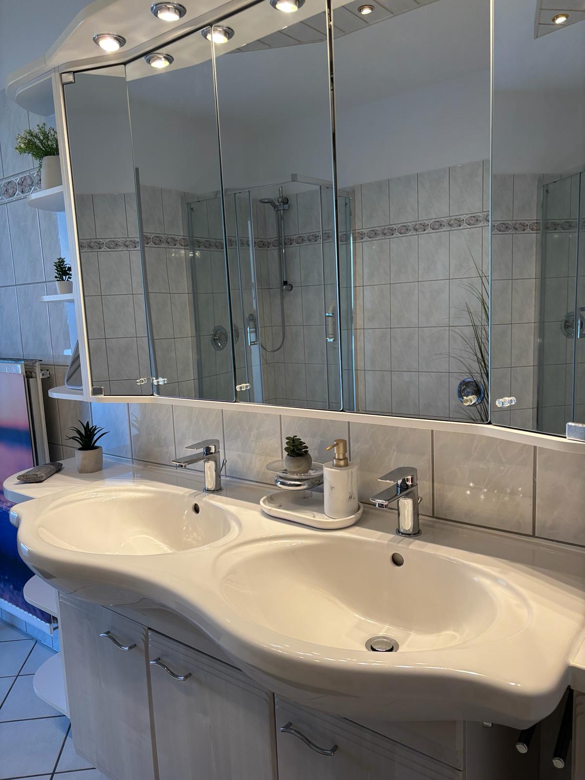 Badezimmer mit Dusche und Doppelwaschbecken